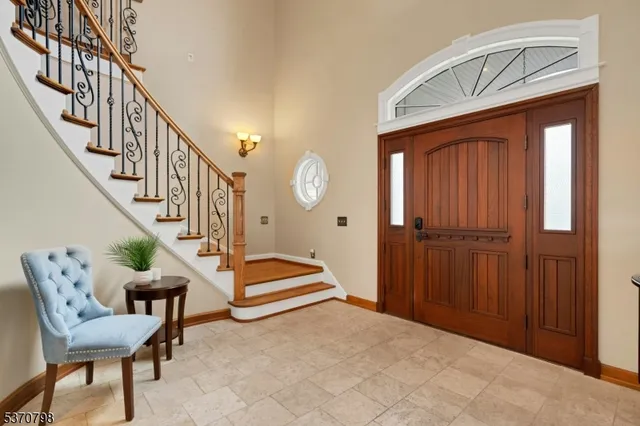 a view of entryway livingroom and hall with wooden floor