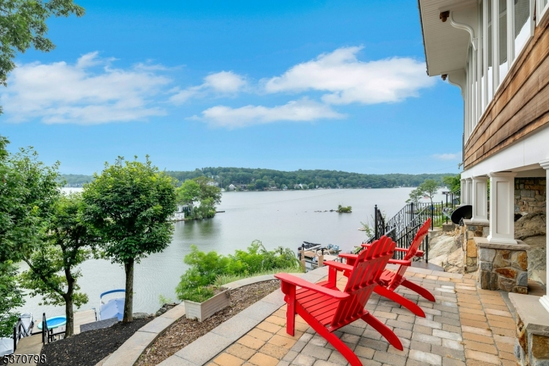 656 Lakeside Avenue Hopatcong, NJ 07821 - Photo 6 of 36 a view of a lake with couches chairs and a table