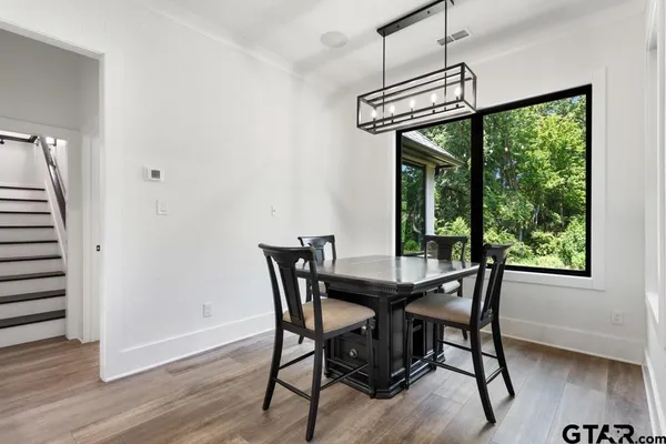 a view of a dining room with furniture window and wooden floor