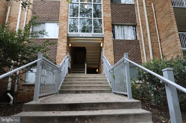 a view of a house with wooden stairs and a porch
