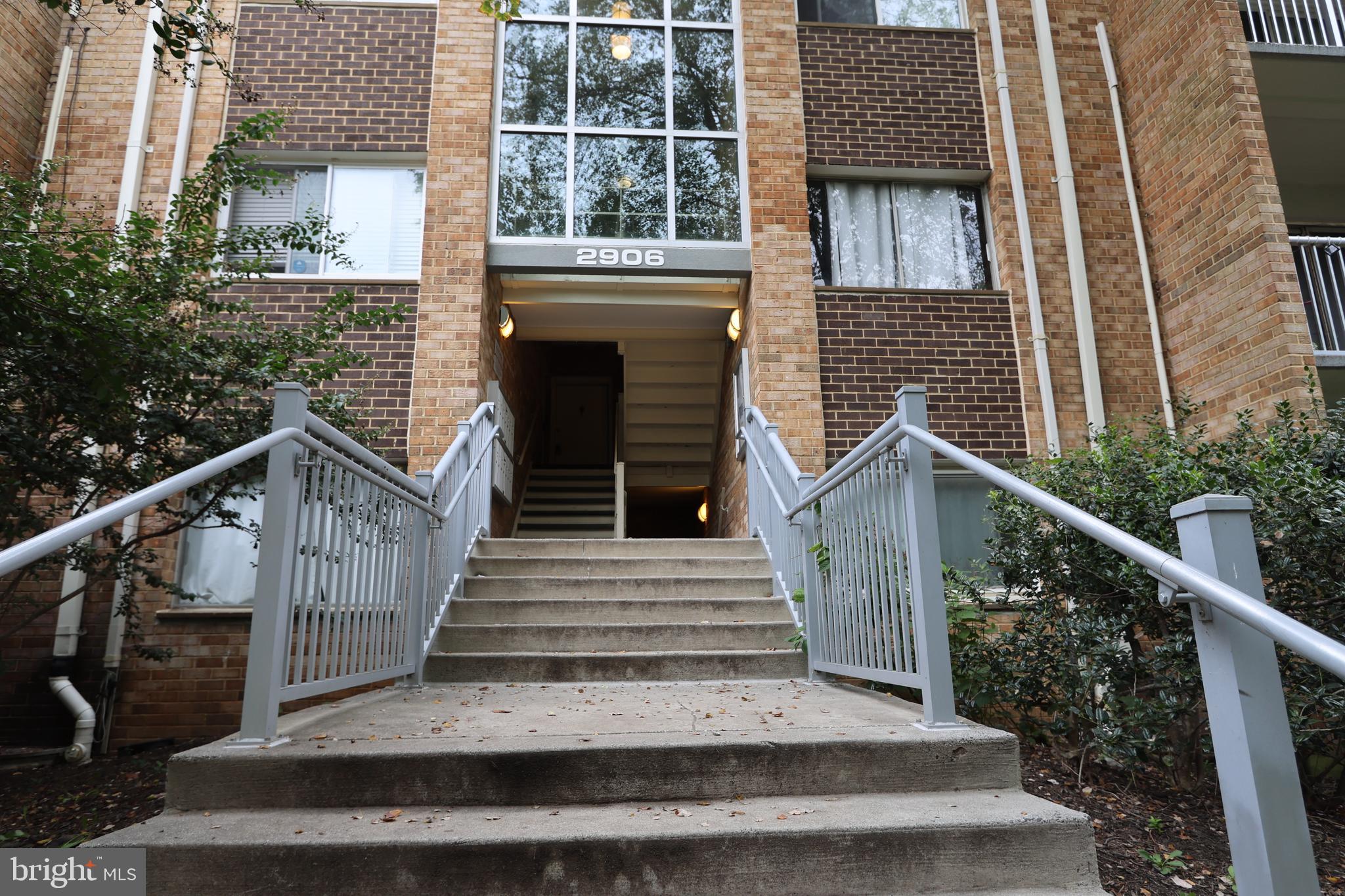 a view of a house with wooden stairs and a porch