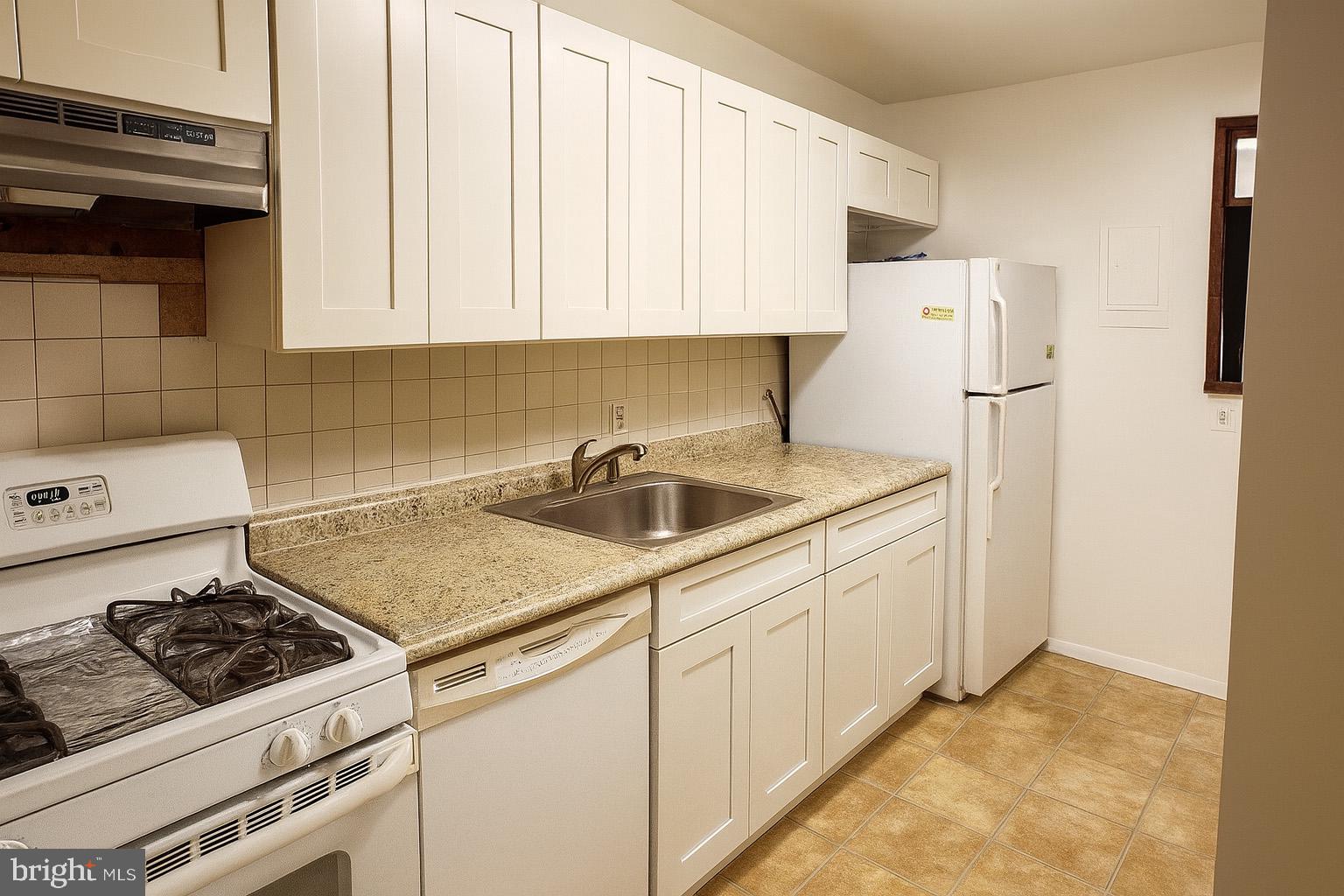 2906 Kings Chapel Road, Unit 6/4 Falls Church, VA 22042 - Photo 8 of 17 a kitchen with a sink stove and cabinets