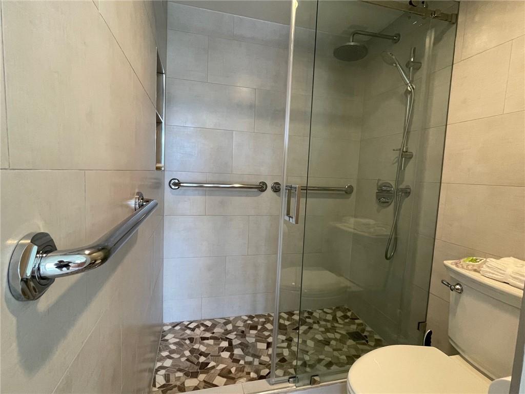 305 North Pompano Beach Boulevard, Unit 1006 Pompano Beach, FL 33062 - Photo 14 of 42 a bathroom with a sink toilet and shower