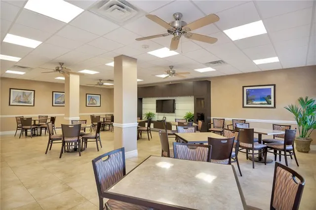 a living room with lots of furniture and view of kitchen