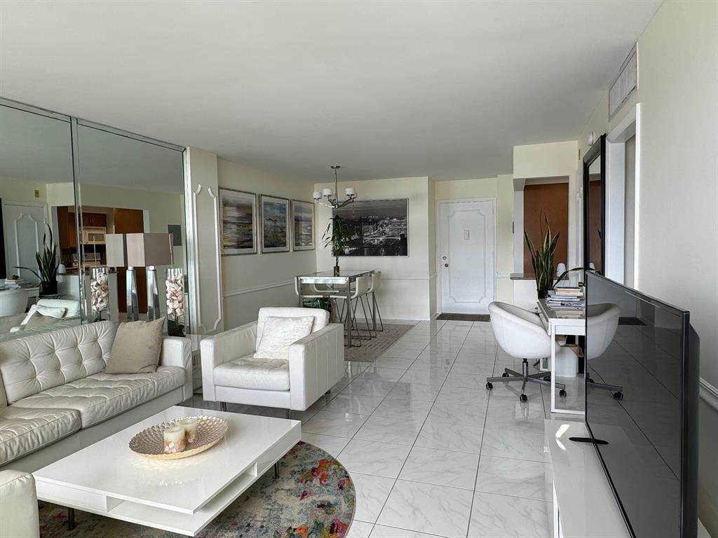 305 North Pompano Beach Boulevard, Unit 1006 Pompano Beach, FL 33062 - Photo 5 of 42 a living room with furniture and a table