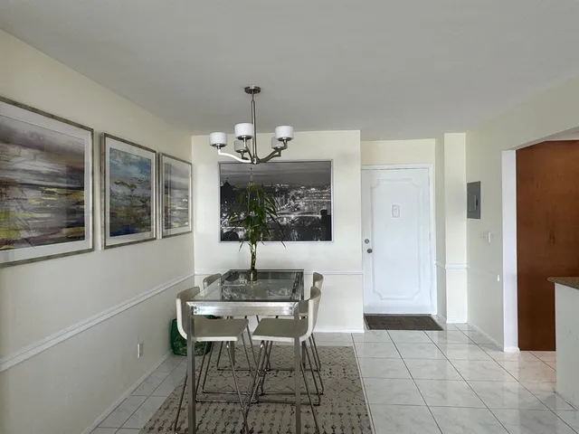 a view of a dining room with furniture and chandelier