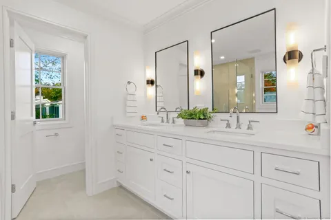 a view of empty room with wooden floor and window