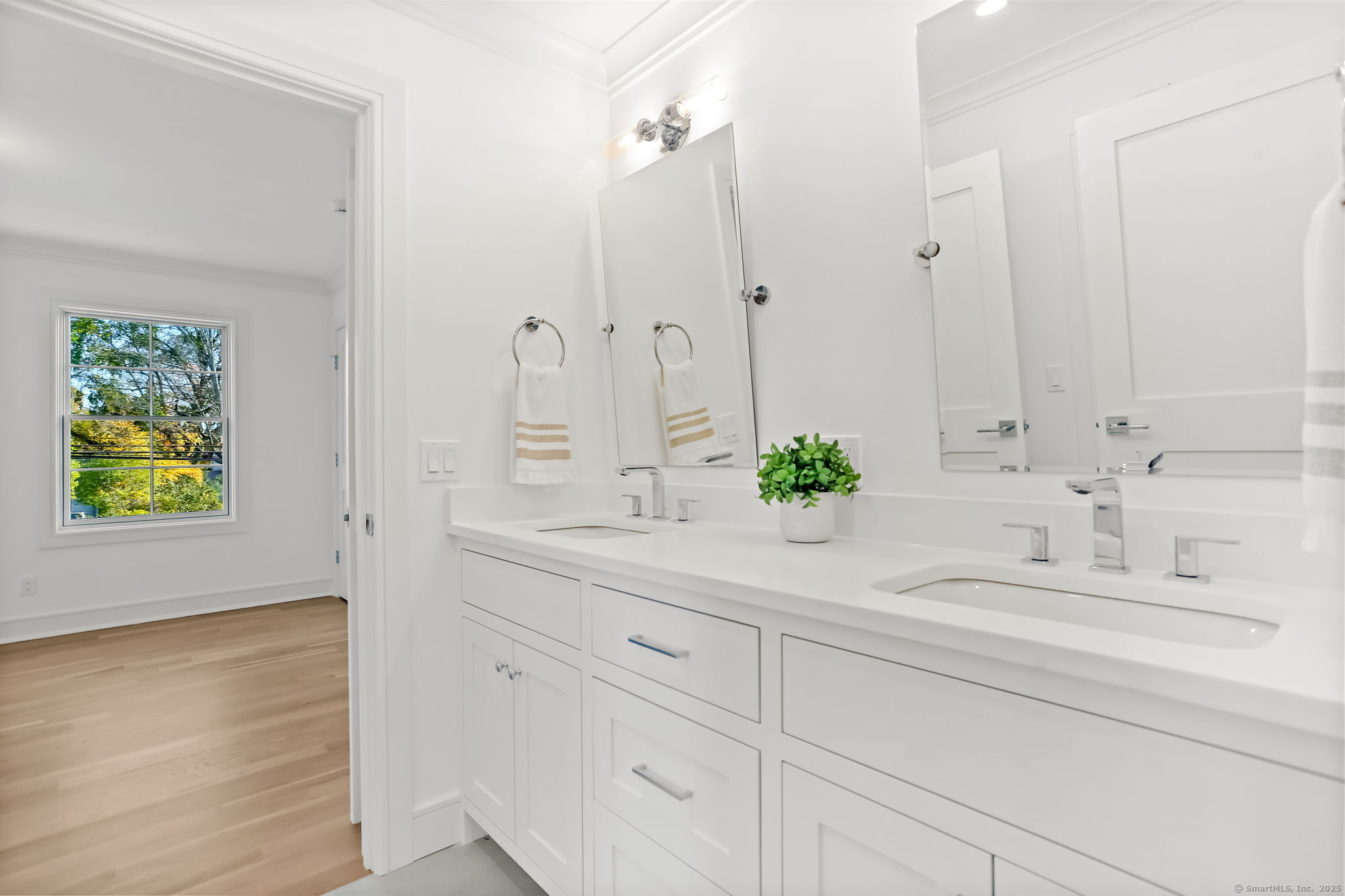 31 High Ridge Road Fairfield, CT 06825 - Photo 26 of 37 a bathroom with a granite countertop sink a potted plant and a window