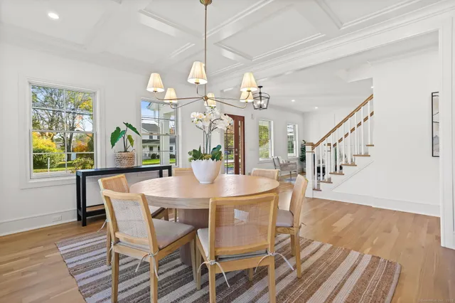 a view of a dining room with furniture and a chandelier