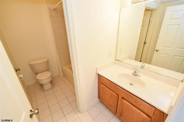 a spacious bathroom with a sink and a mirror