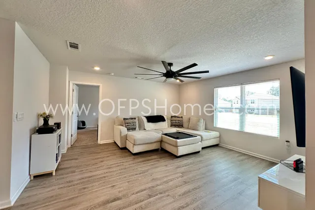 a living room with furniture and a large window