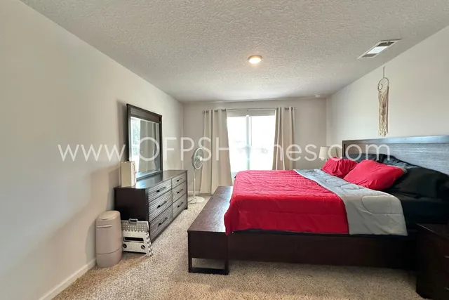 a bedroom with a bed and a couch