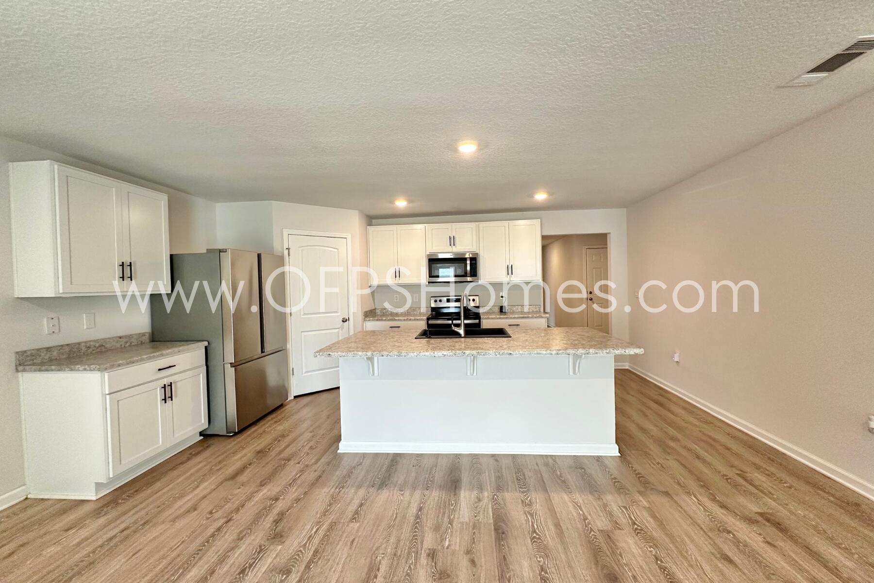 3582 Sugar Maple Lane Crestview, FL 32539 - Photo 14 of 33 a view of kitchen with wooden floor and electronic appliances