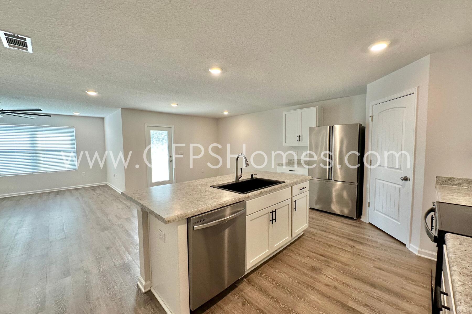 3582 Sugar Maple Lane Crestview, FL 32539 - Photo 15 of 33 a kitchen with stainless steel appliances granite countertop a stove and a refrigerator