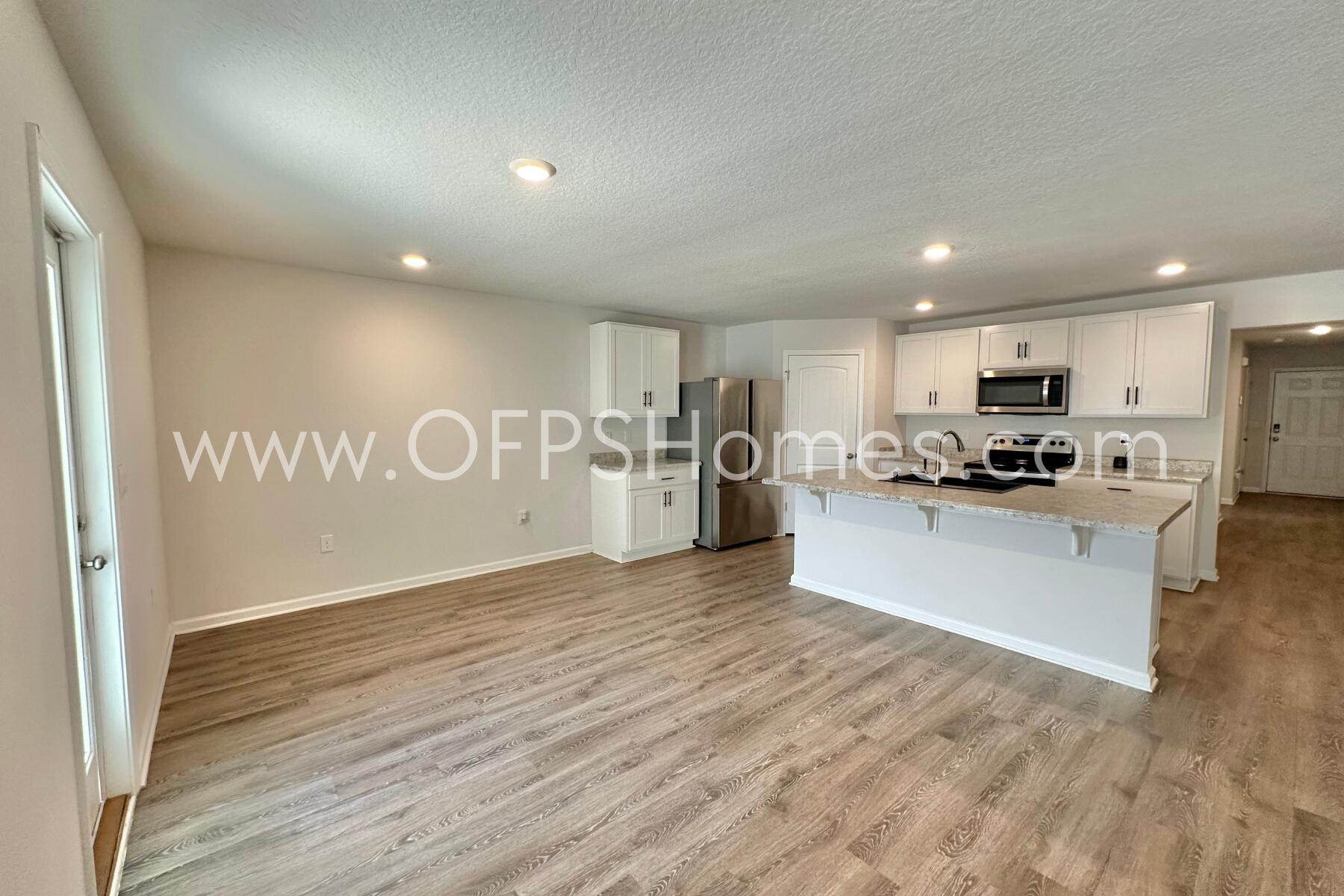 3582 Sugar Maple Lane Crestview, FL 32539 - Photo 18 of 33 a view of a kitchen with a sink and a refrigerator