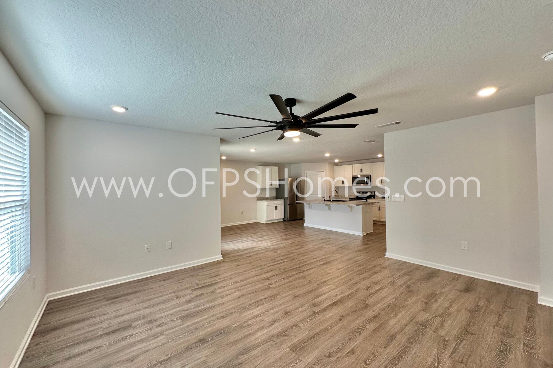 3582 Sugar Maple Lane Crestview, FL 32539 - Photo 24 of 33 a view of a refrigerator in kitchen and wooden floor