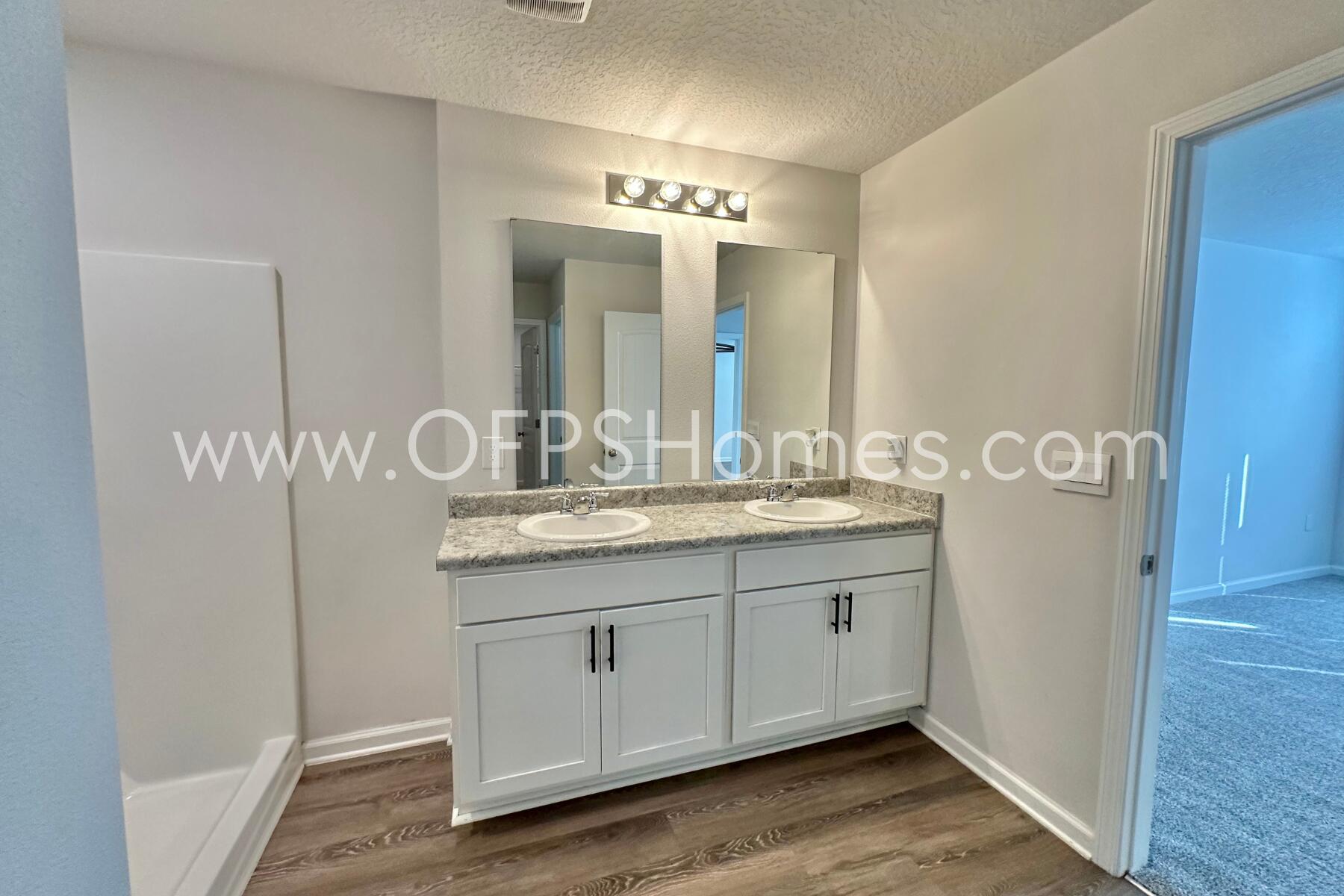 3582 Sugar Maple Lane Crestview, FL 32539 - Photo 29 of 33 a bathroom with a double vanity sink and a mirror