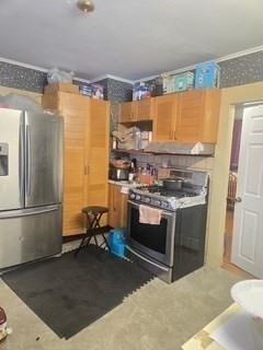 17 Spencer Street Springfield, MA 01118 - Photo 5 of 14 a kitchen with stainless steel appliances granite countertop a stove a refrigerator and a sink