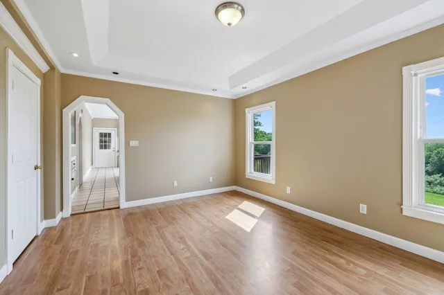 a kitchen with stainless steel appliances granite countertop a stove a sink and dishwasher with white cabinets