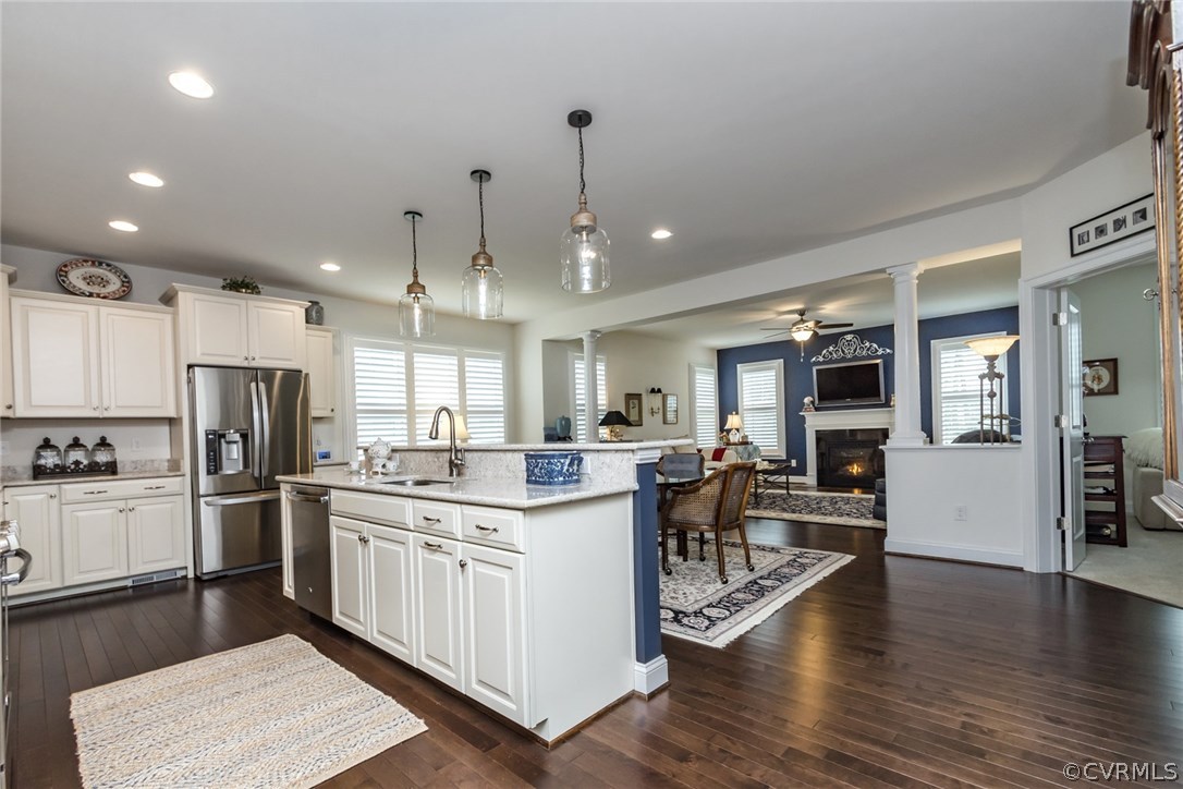 1372 Miners Trail Road Midlothian, VA 23114 - Photo 10 of 50 a kitchen with stainless steel appliances kitchen island granite countertop a stove a sink a refrigerator and white cabinets with wooden floor