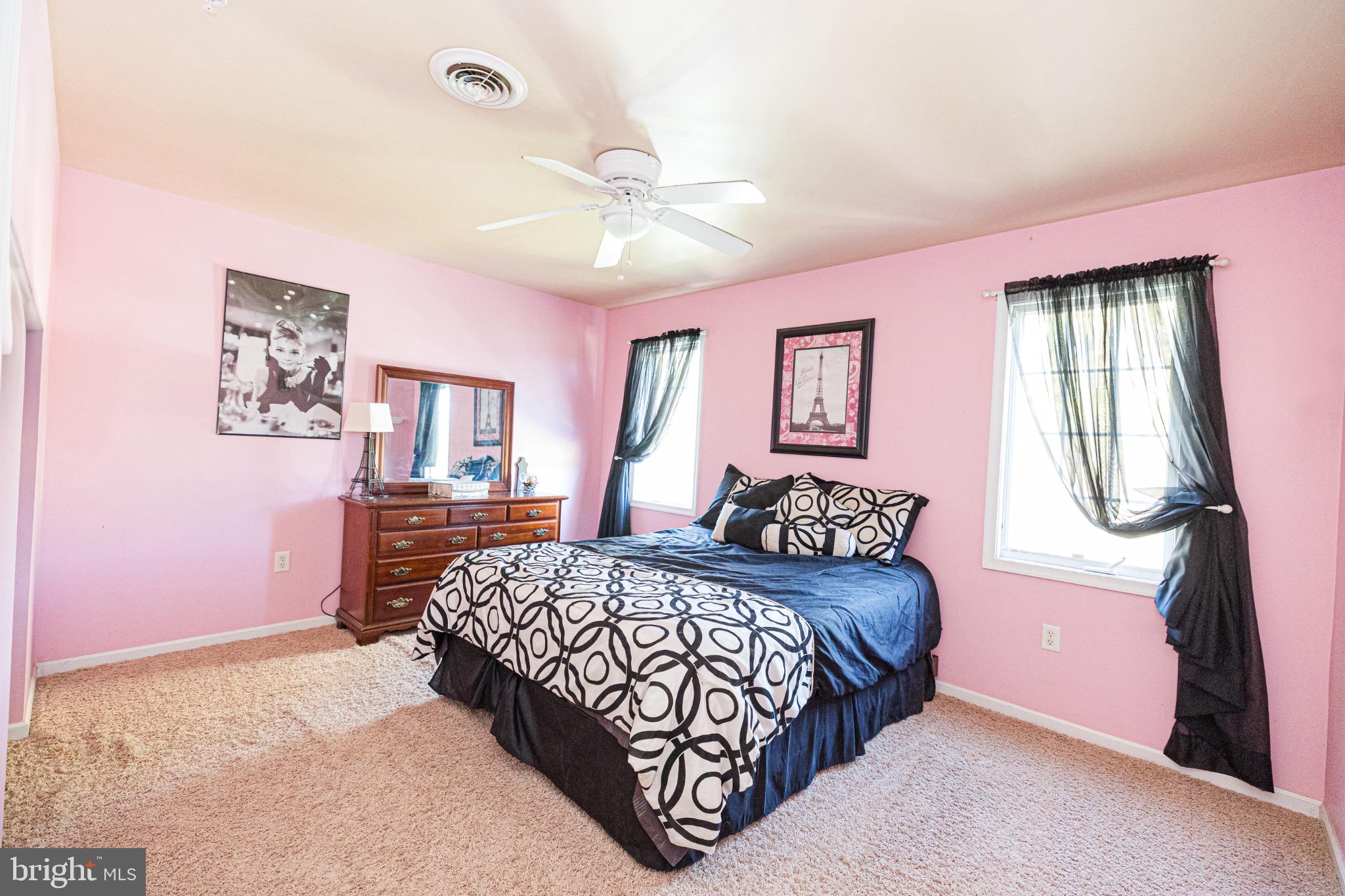 2561 Cedar Ridge Drive Westminster, MD 21158 - Photo 18 of 38 a bedroom with a large bed and a chandelier