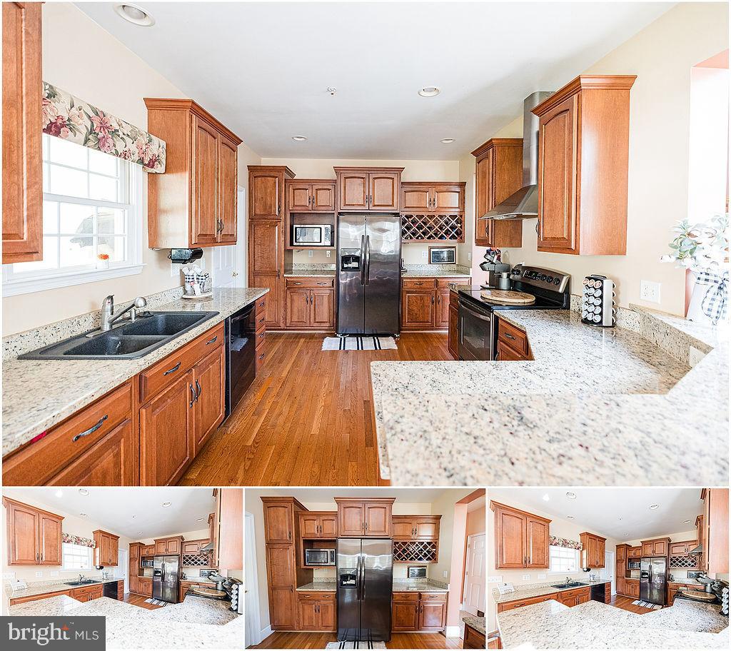 2561 Cedar Ridge Drive Westminster, MD 21158 - Photo 31 of 38 a upper view of a kitchen with stainless steel appliances granite countertop a sink and counter space