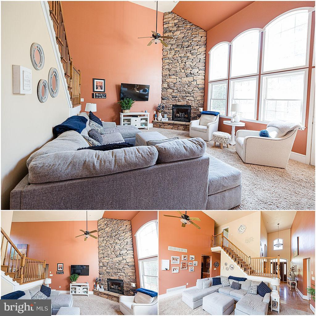 2561 Cedar Ridge Drive Westminster, MD 21158 - Photo 32 of 38 a living room with furniture and a floor to ceiling window