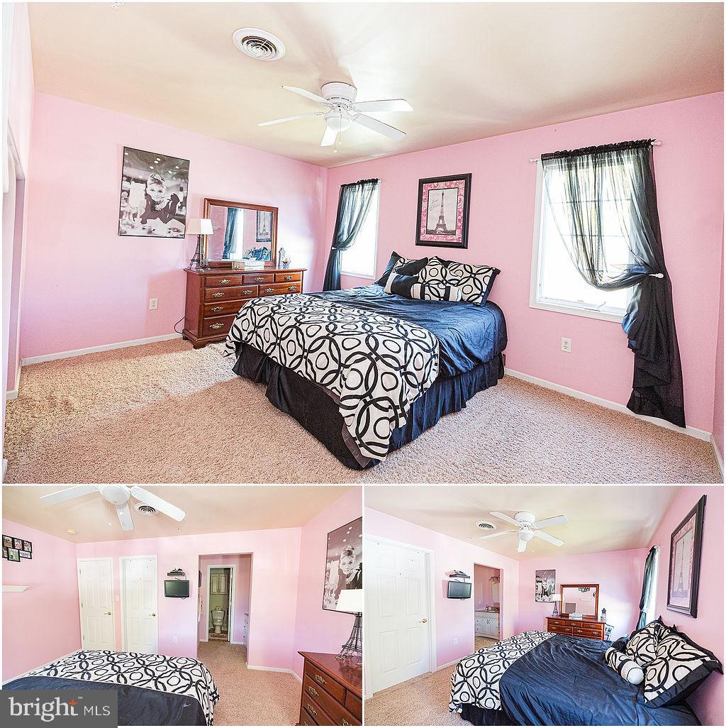 2561 Cedar Ridge Drive Westminster, MD 21158 - Photo 34 of 38 a bedroom with a bed a chandelier and dresser