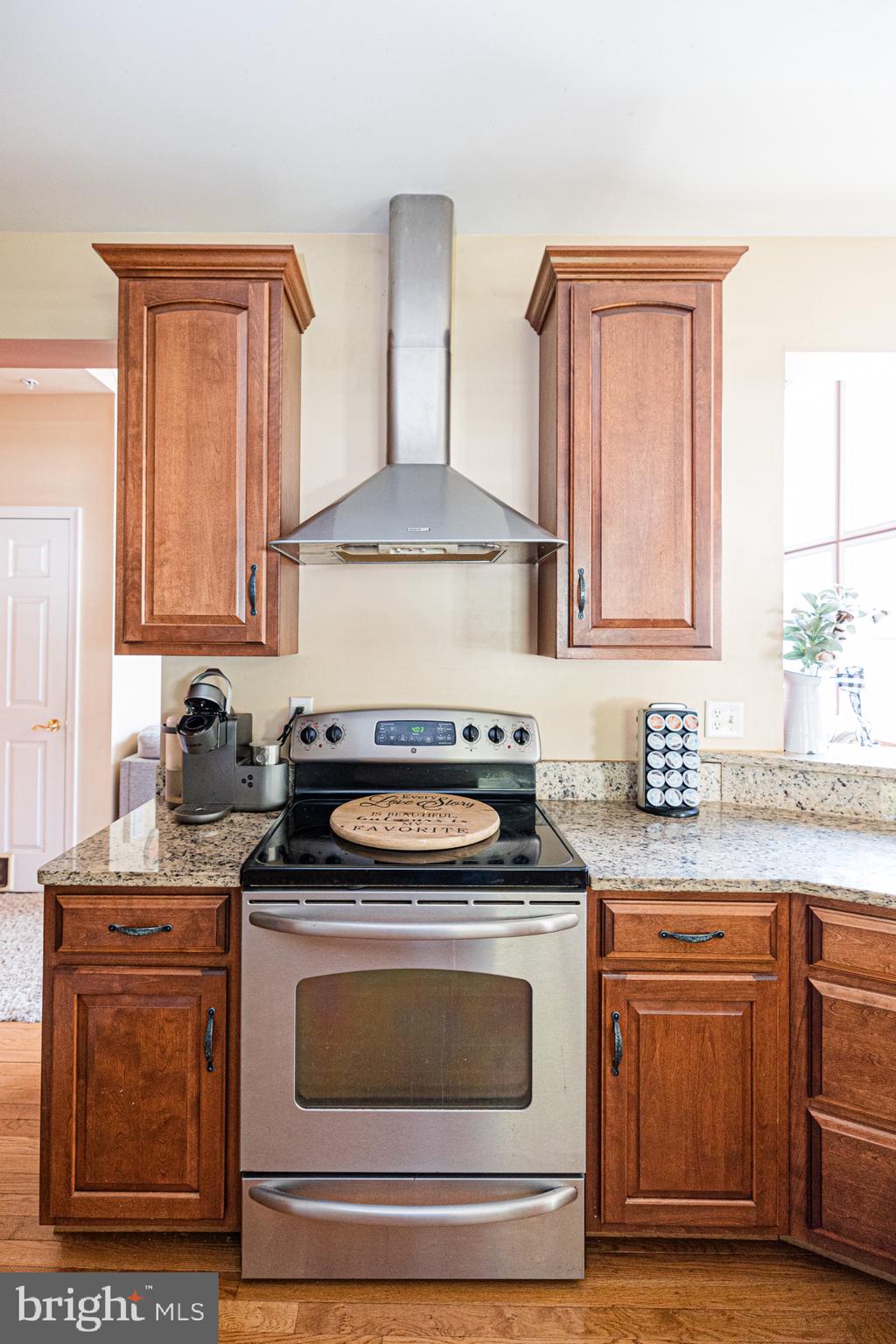 2561 Cedar Ridge Drive Westminster, MD 21158 - Photo 5 of 38 a kitchen with granite countertop a stove top oven sink and cabinets