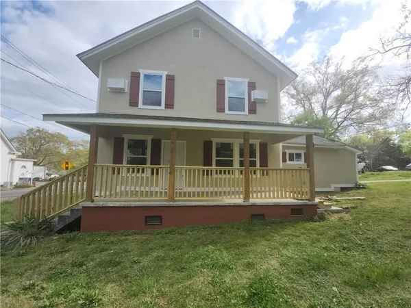 a front view of a house with a yard