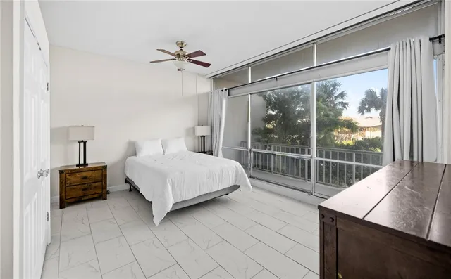 a bedroom with a large bed and a large window
