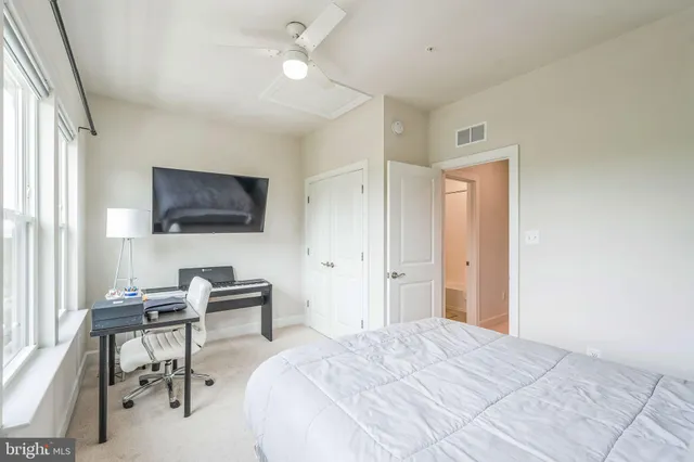 a bedroom with a bed and a flat screen tv