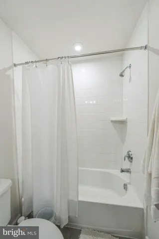 a bathroom with a shower and a toilet