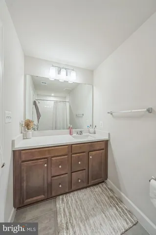 a bathroom with a granite countertop sink a toilet and a mirror