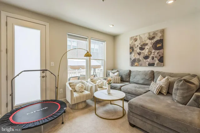 a living room with furniture a table and a large window