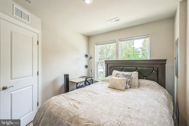 a bedroom with a bed and window