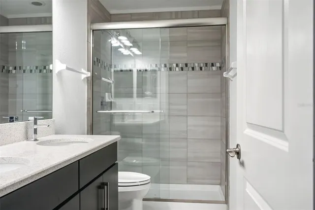 a bathroom with a shower sink and mirror
