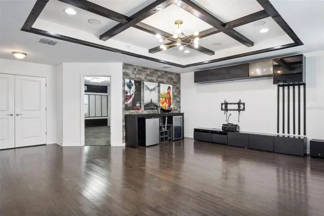 a view of a livingroom with furniture and hardwood floor