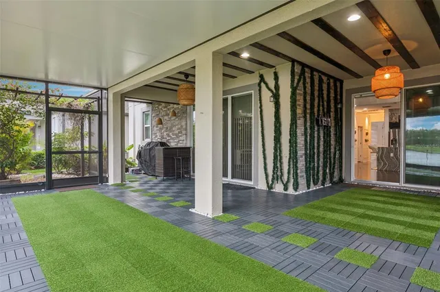 a view of a porch with a floor to ceiling window and yard