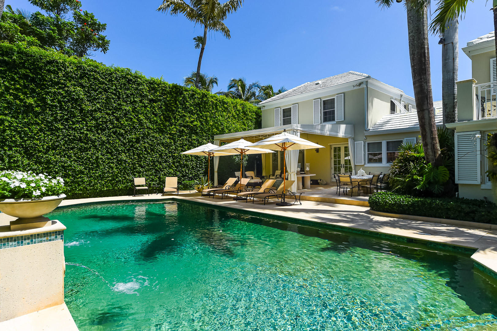 130 Cocoanut Row Palm Beach, FL 33480 - Photo 2 of 31 a view of a house with swimming pool and porch with furniture