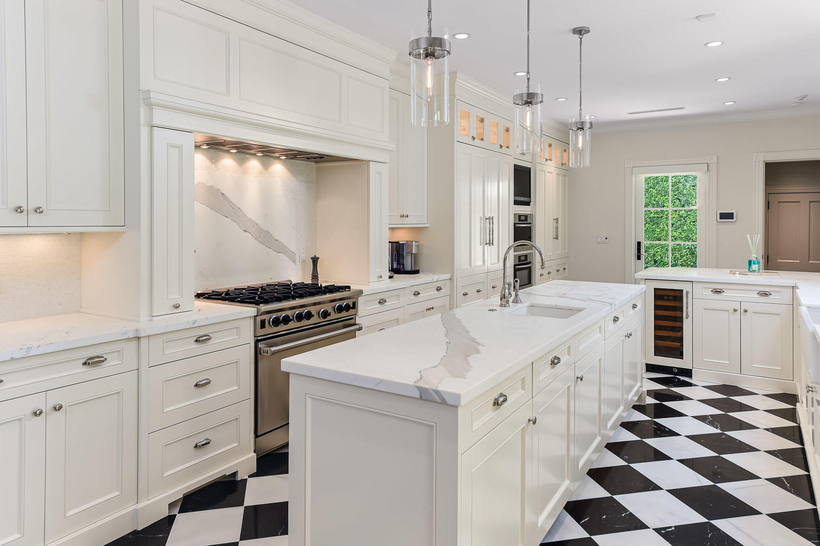 130 Cocoanut Row Palm Beach, FL 33480 - Photo 6 of 31 a kitchen with white cabinets and appliances