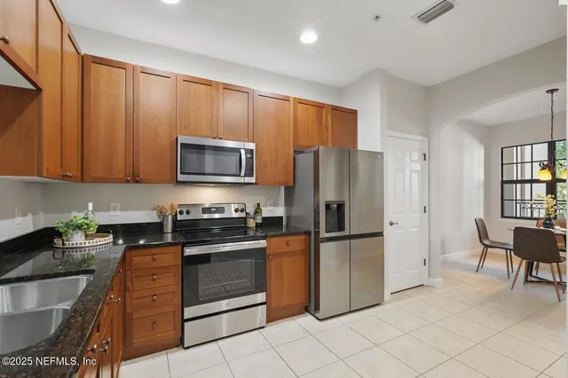 an aerial view of a residential apartment building with a yard