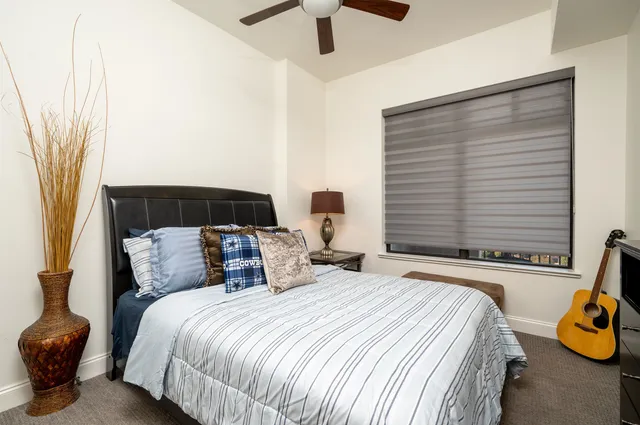 a bedroom with a bed and a window