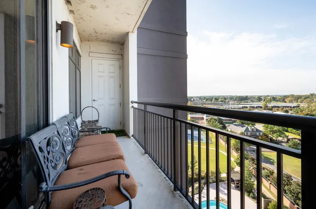 a balcony with furniture and city view