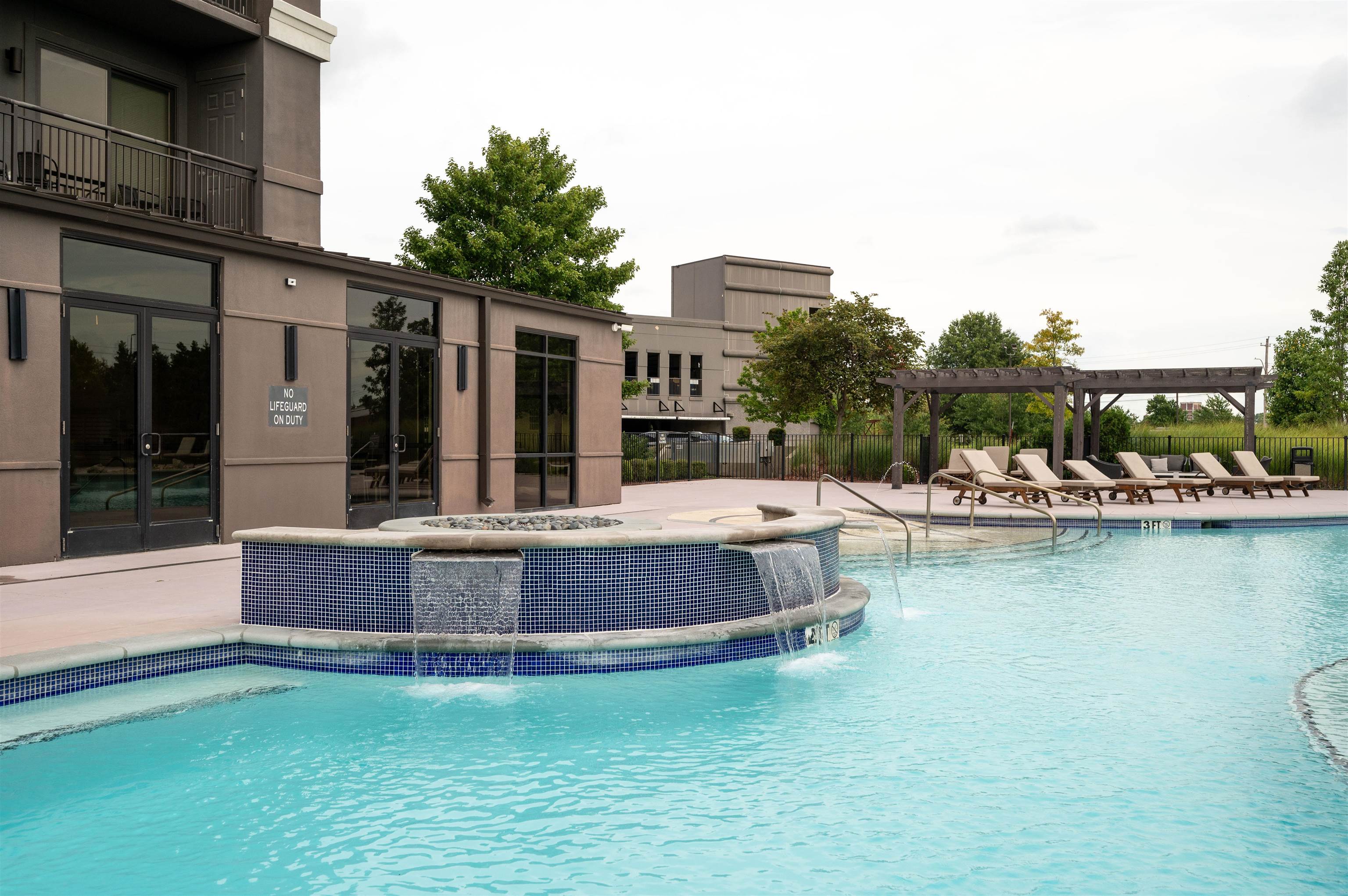 717 Riverside Drive, Unit 903 Memphis, TN 38103 - Photo 32 of 33 a view of a swimming pool with outdoor seating and a lake view