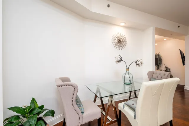 a view of a dining room with furniture and a potted plant