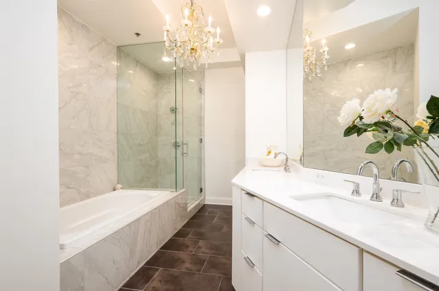 a bathroom with a tub sink and mirror