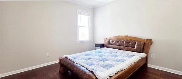 a bedroom with a bed and window