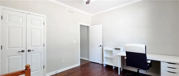 a view of a workspace with furniture and wooden floor