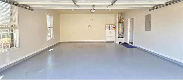 a view of a big room with wooden floor and windows